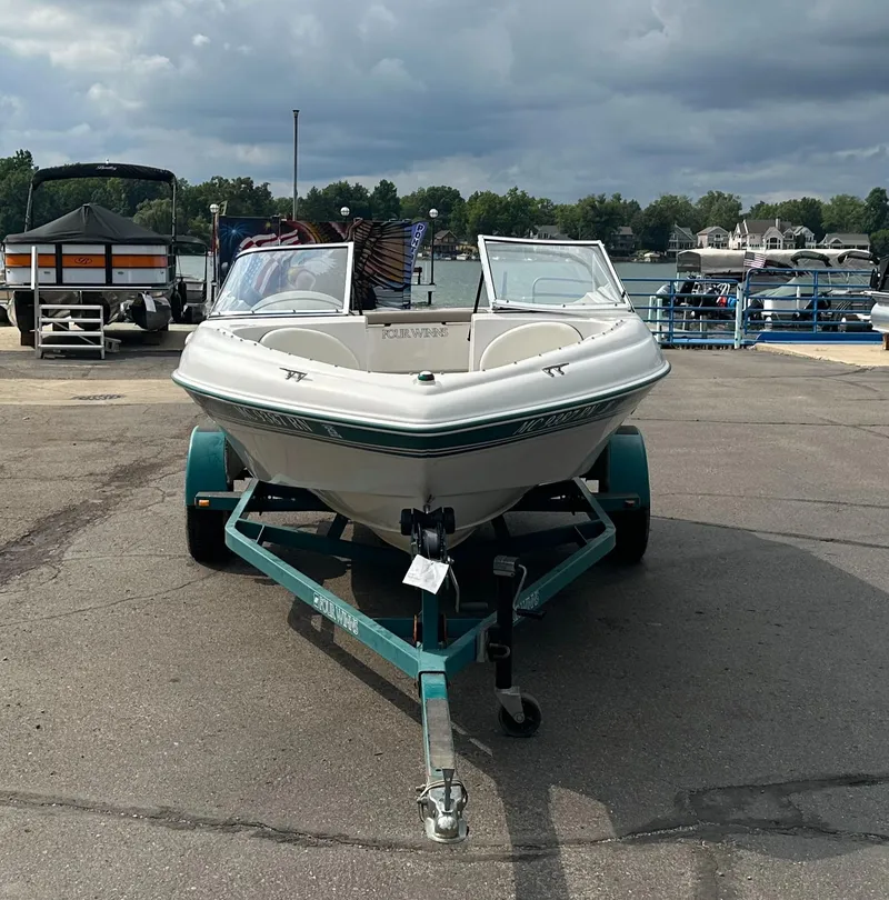 Slide: The Image of 1997 Four Winns Horizon QX boat on trailer, parked at marina. - 5
