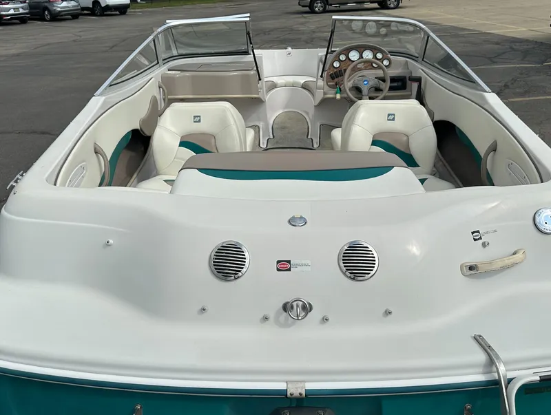 Slide: The Image of 1997 Four Winns Horizon QX boat interior with white and teal seating. - 7