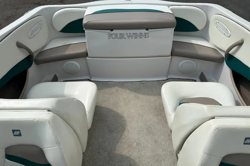 Slide: The Image of 1997 Four Winns Horizon QX boat interior with white and gray seating. - 8