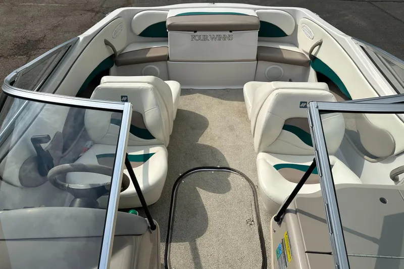 Slide: The Image of 1997 Four Winns Horizon QX boat interior with white and green seating. - 9