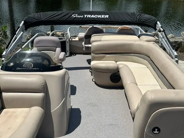 Slide: The Image of 2015 Sun Tracker Fishing Barge 24 with spacious seating on a calm lake. - 5