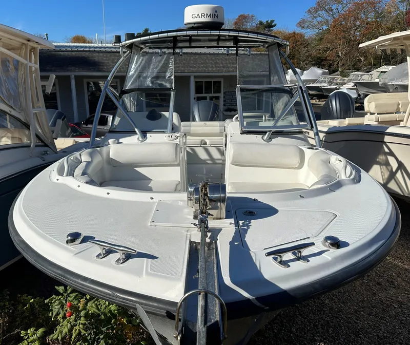 Slide: The Image of 2011 Edgewater 245 CX boat with Garmin equipment, docked in a marina. - 1