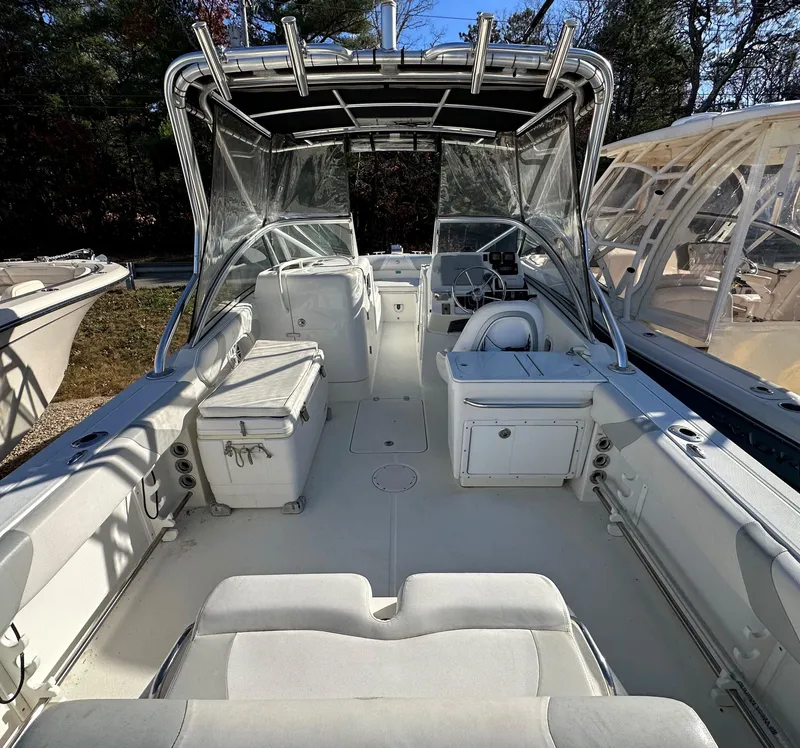 Slide: The Image of 2011 Edgewater 245 CX boat interior with seating, storage, and helm station. - 10