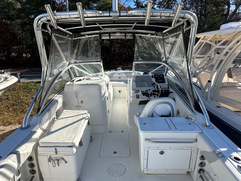 Slide: The Image of 2011 Edgewater 245 CX boat interior with seating and storage compartments. - 11