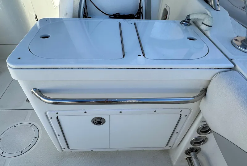 Slide: The Image of Edgewater 245 CX 2011 boat interior with storage compartment and sink. - 12