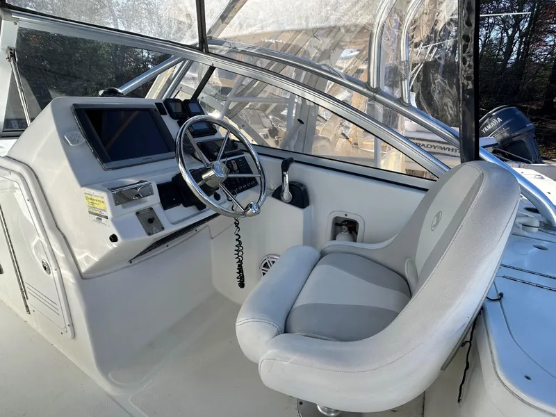 Slide: The Image of Edgewater 245 CX 2011 boat cockpit with steering wheel and control panel. - 4