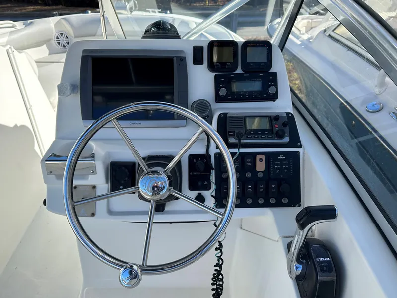 Slide: The Image of Edgewater 245 CX 2011 boat dashboard with steering wheel and navigation controls. - 5