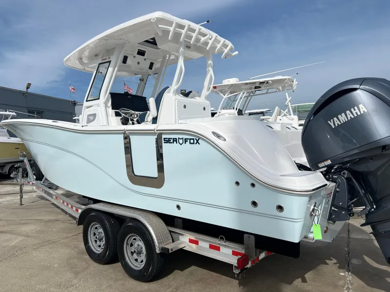 Slide: The Image of 2025 Sea Fox 288 Commander boat on trailer with Yamaha engine, outdoor display. - 2