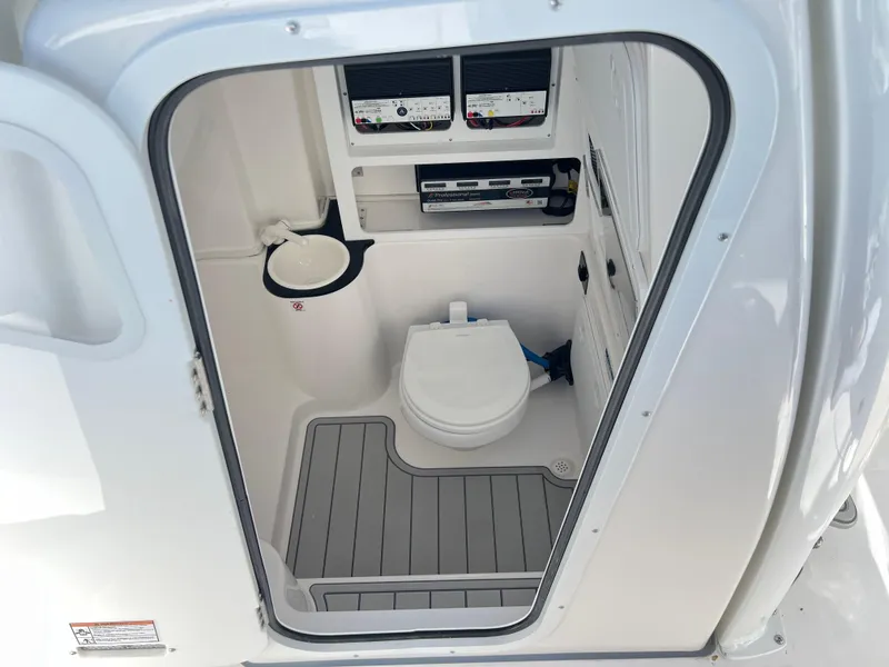 Slide: The Image of 2025 Sea Fox 288 Commander boat interior with compact marine toilet and storage. - 36
