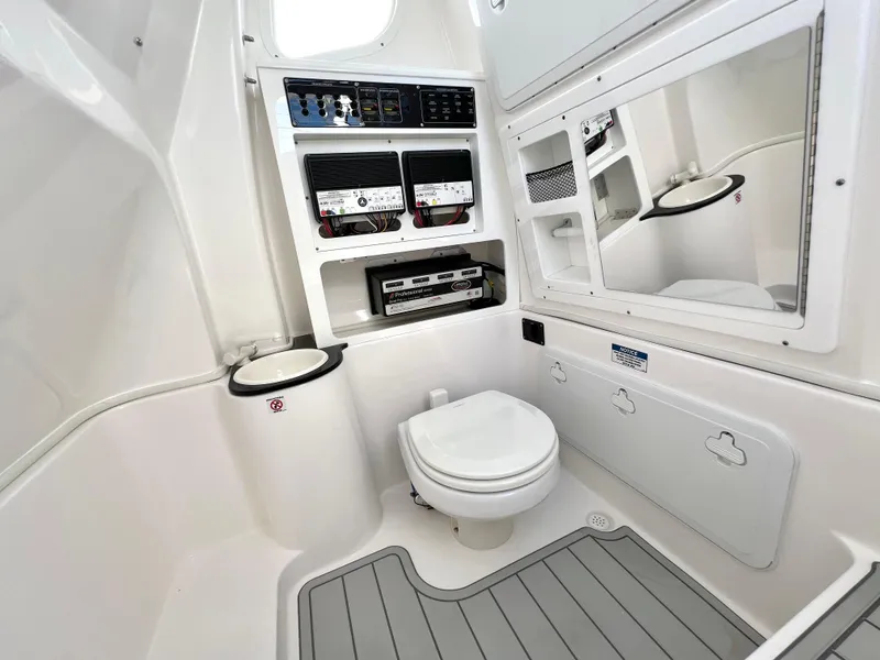 Slide: The Image of 2025 Sea Fox 288 Commander boat bathroom with toilet, storage, and mirror. - 38
