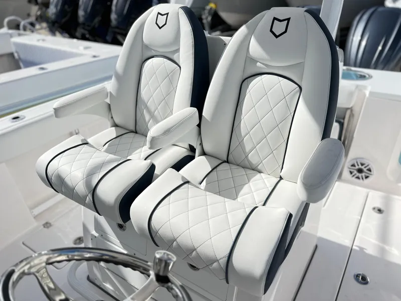 Slide: The Image of 2025 Sea Fox 288 Commander boat seats with white quilted upholstery and armrests. - 43
