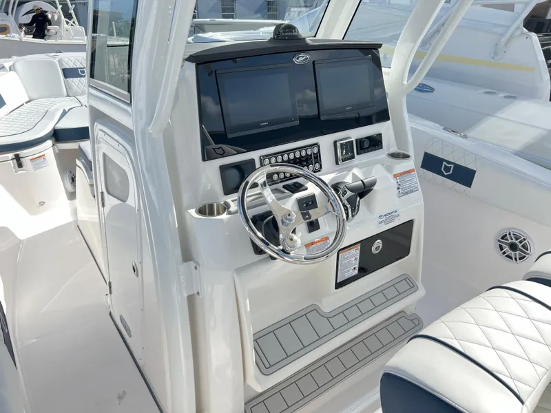 Slide: The Image of 2025 Sea Fox 288 Commander boat dashboard with dual screens and steering wheel. - 44