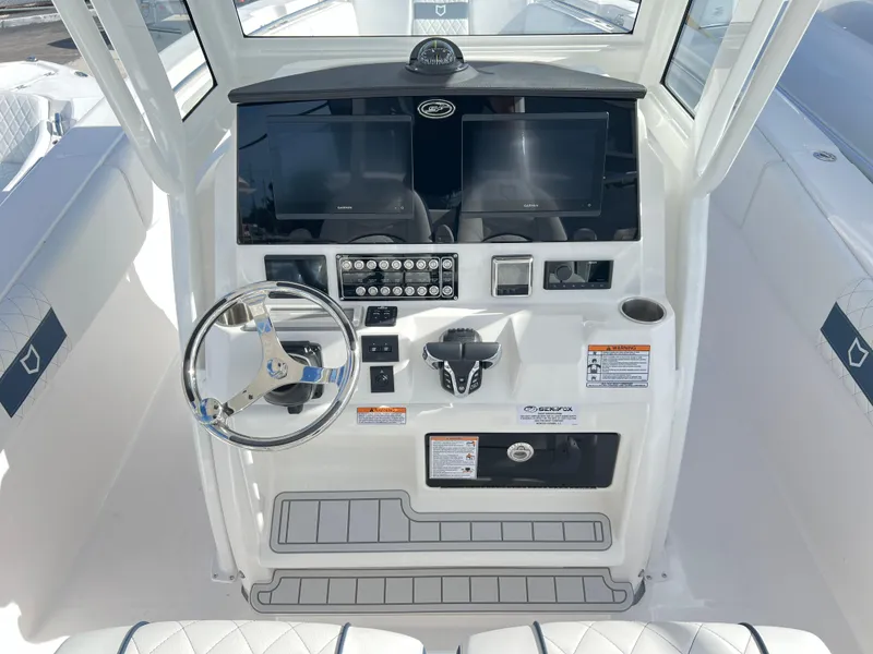 Slide: The Image of 2025 Sea Fox 288 Commander boat dashboard with dual screens and steering wheel. - 45