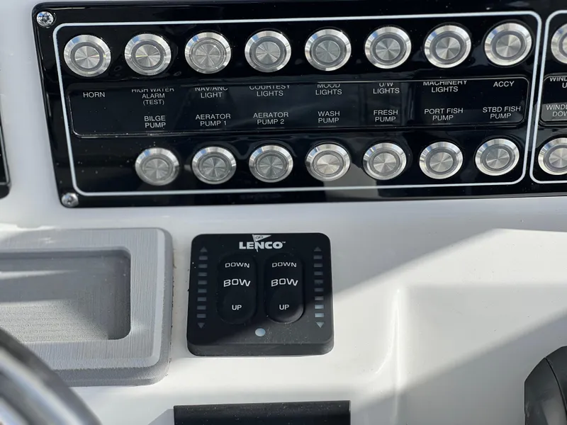 Slide: The Image of Control panel of 2025 Sea Fox 288 Commander boat with labeled switches and Lenco trim tab controls. - 49