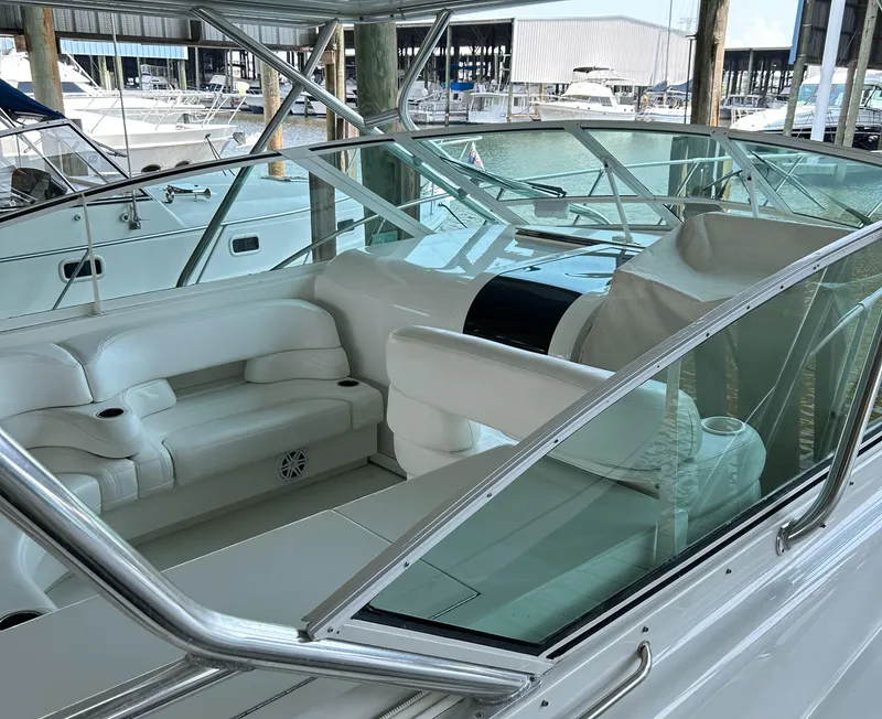Slide: The Image of 1996 Hatteras 39 Sport Express boat interior with white seating and glass windshield. - 15