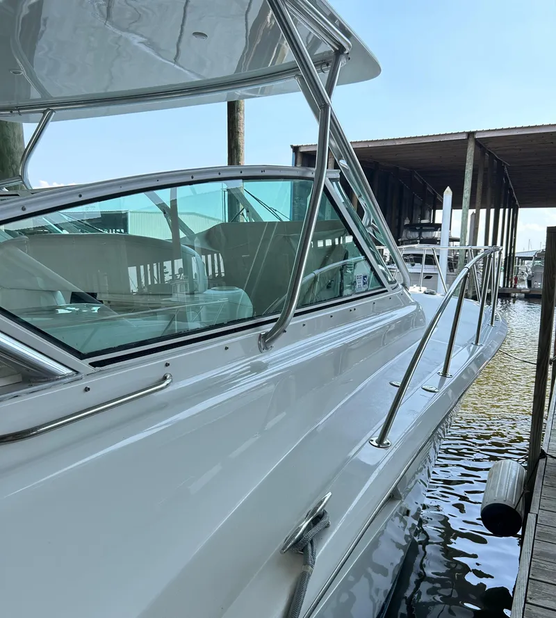 Slide: The Image of 1996 Hatteras 39 Sport Express docked at marina, side view. - 16