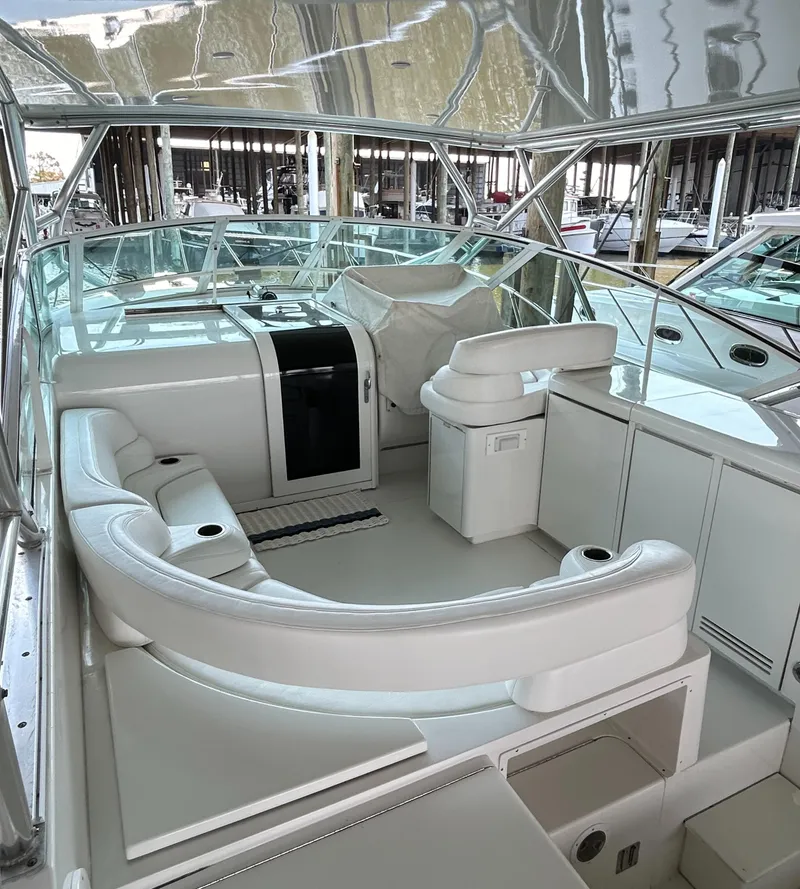 Slide: The Image of 1996 Hatteras 39 Sport Express boat interior with white seating and helm. - 20