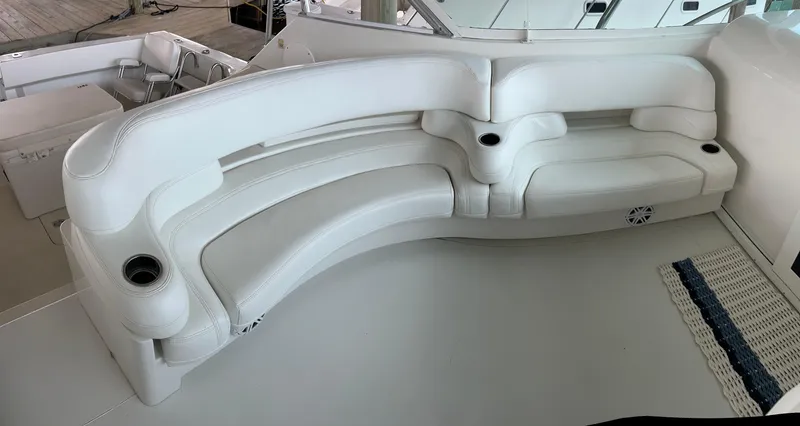 Slide: The Image of White leather seating on 1996 Hatteras 39 Sport Express yacht, featuring cup holders. - 21