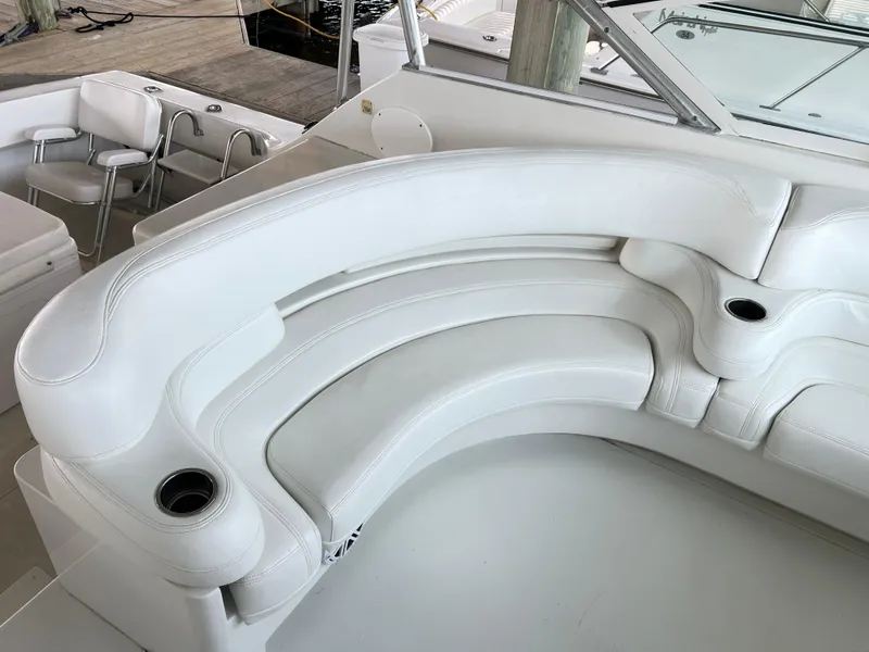 Slide: The Image of Luxurious white seating on 1996 Hatteras 39 Sport Express yacht, featuring cup holders. - 22