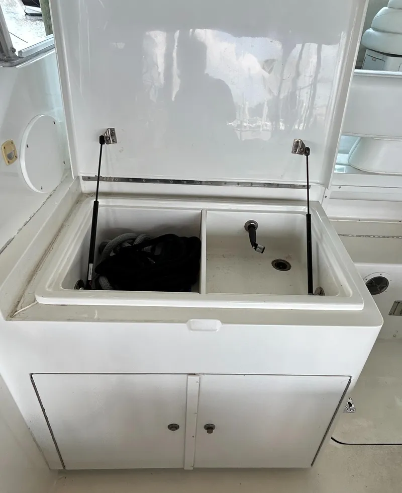 Slide: The Image of 1996 Hatteras 39 Sport Express boat sink and storage area. - 25