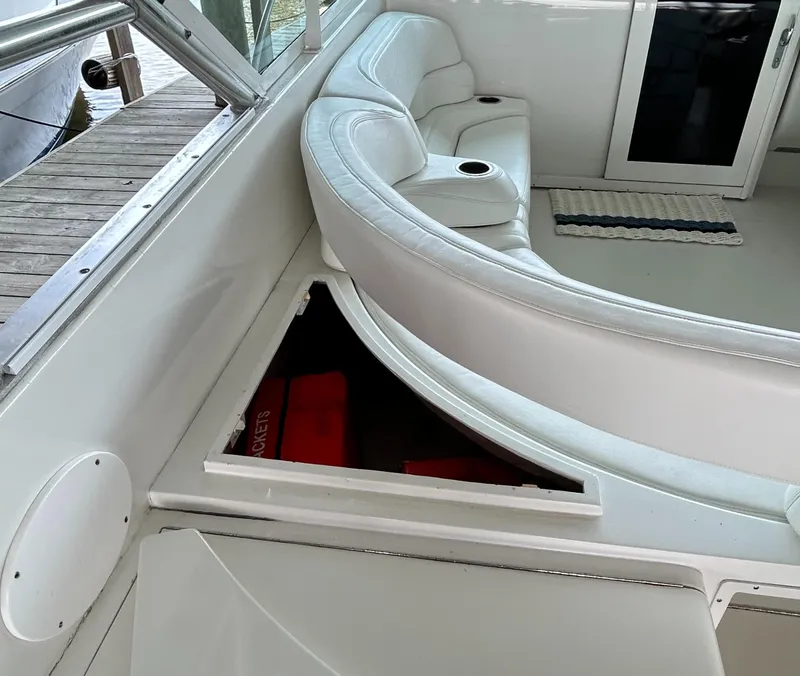 Slide: The Image of 1996 Hatteras 39 Sport Express interior with white seating and storage compartment. - 27