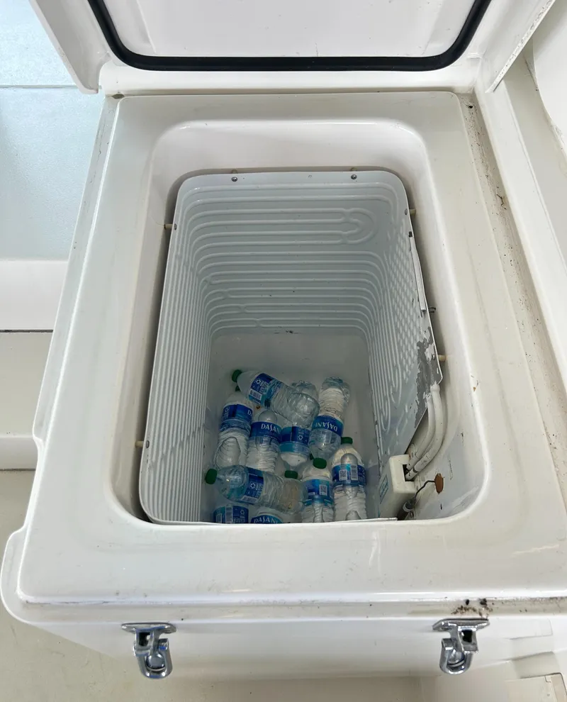 Slide: The Image of Open cooler with water bottles on a 1996 Hatteras 39 Sport Express boat. - 29