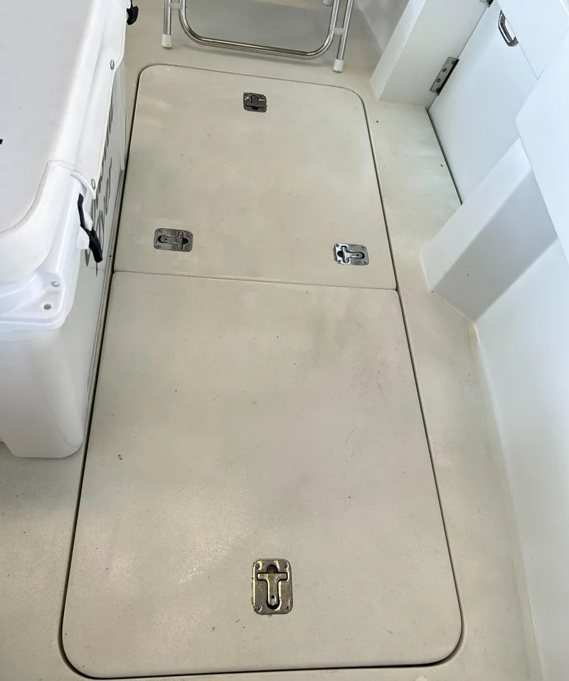 Slide: The Image of Hatteras 39 Sport Express 1996 deck hatch with secure latches and white flooring. - 30