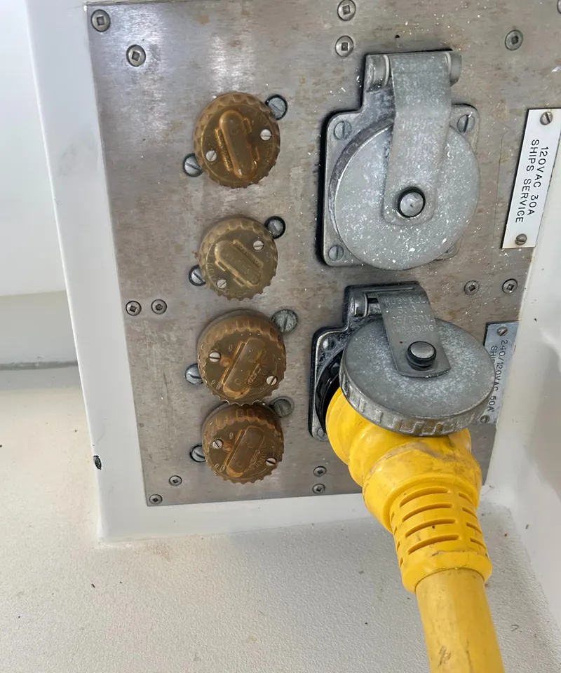 Slide: The Image of Electrical panel with yellow power cable on 1996 Hatteras 39 Sport Express boat. - 32