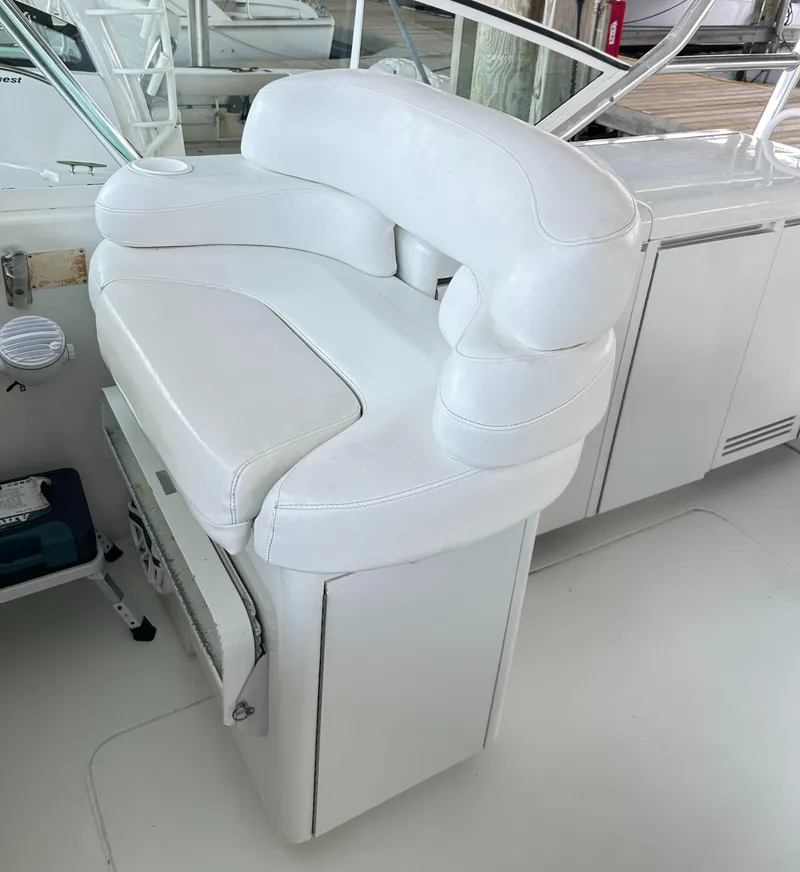 Slide: The Image of White captain's chair on 1996 Hatteras 39 Sport Express boat deck. - 34