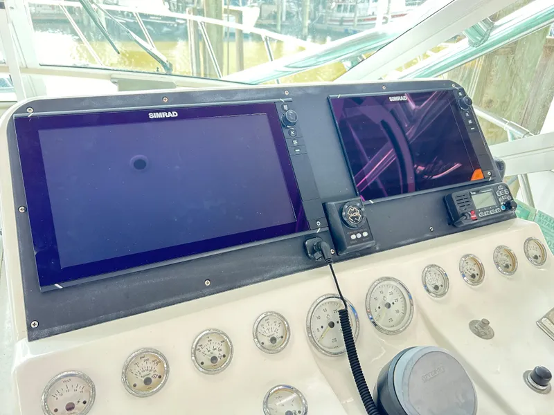 Slide: The Image of Control panel of 1996 Hatteras 39 Sport Express with Simrad displays and gauges. - 38