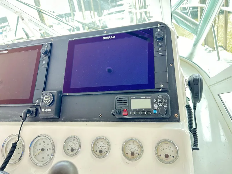 Slide: The Image of Control panel of a 1996 Hatteras 39 Sport Express with navigation screens and gauges. - 39