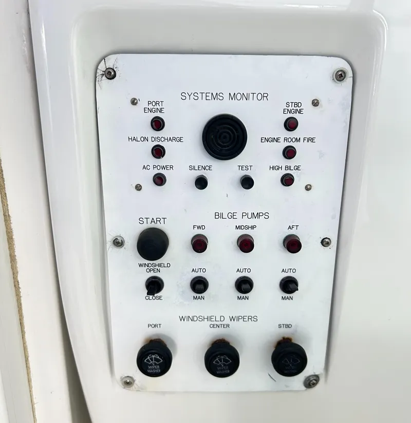 Slide: The Image of Control panel of a 1996 Hatteras 39 Sport Express boat, featuring system monitors and bilge pump controls. - 41