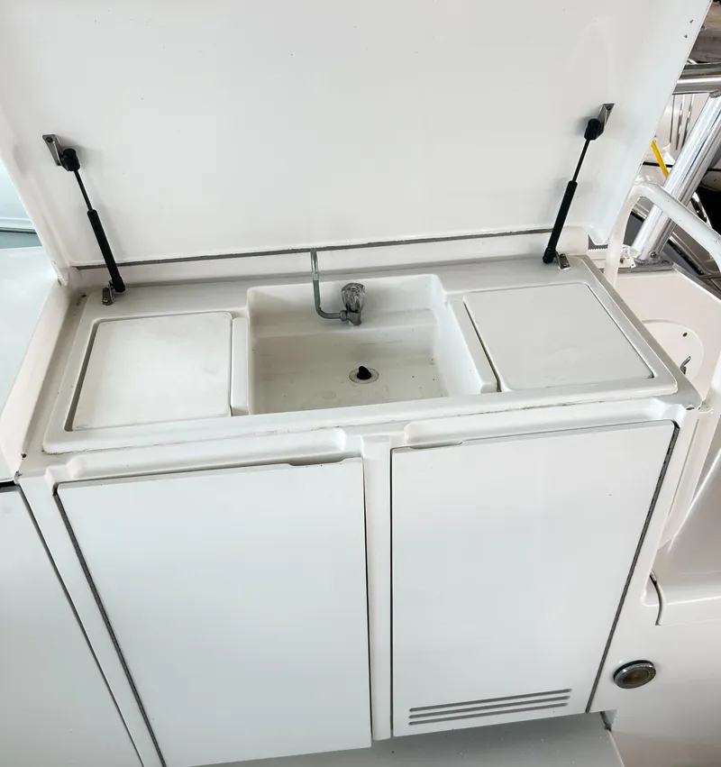 Slide: The Image of 1996 Hatteras 39 Sport Express boat sink with storage compartments. - 42