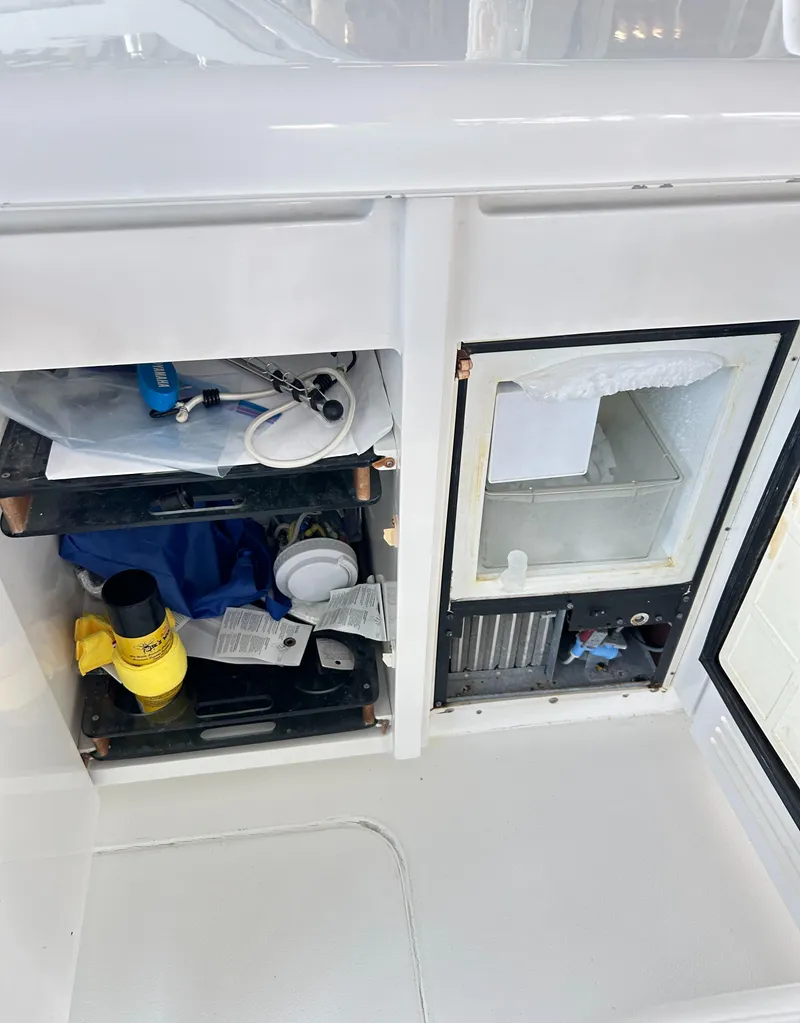 Slide: The Image of Storage compartments on a 1996 Hatteras 39 Sport Express boat, featuring various tools and equipment. - 43