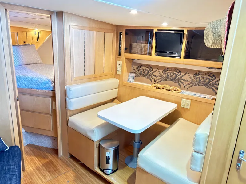 Slide: The Image of 1996 Hatteras 39 Sport Express interior with dining area and cozy cabin. - 46