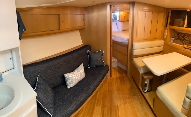 Slide: The Image of Interior of 1996 Hatteras 39 Sport Express yacht with cozy seating and wooden finishes. - 47