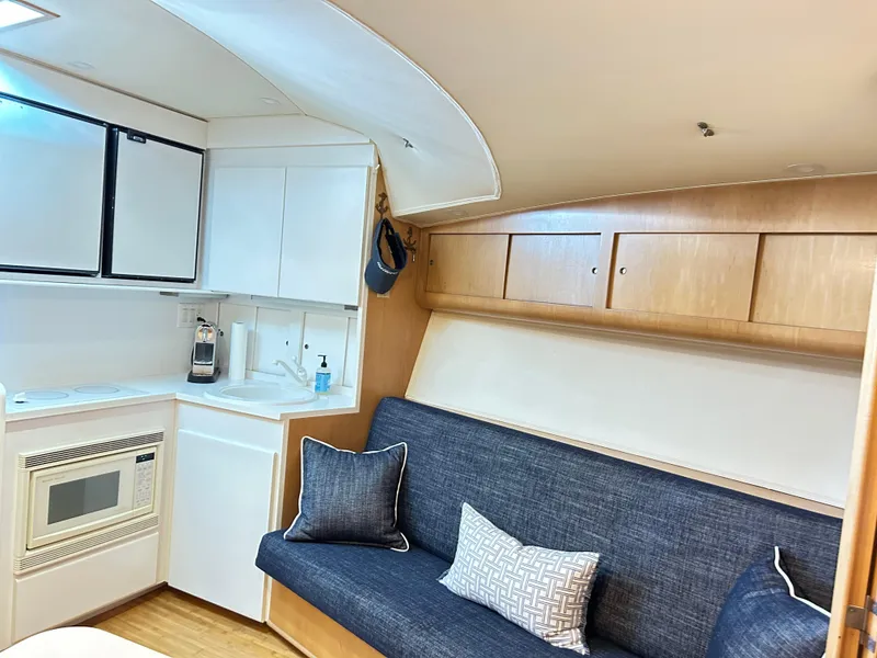 Slide: The Image of Interior of 1996 Hatteras 39 Sport Express with kitchenette and seating area. - 48