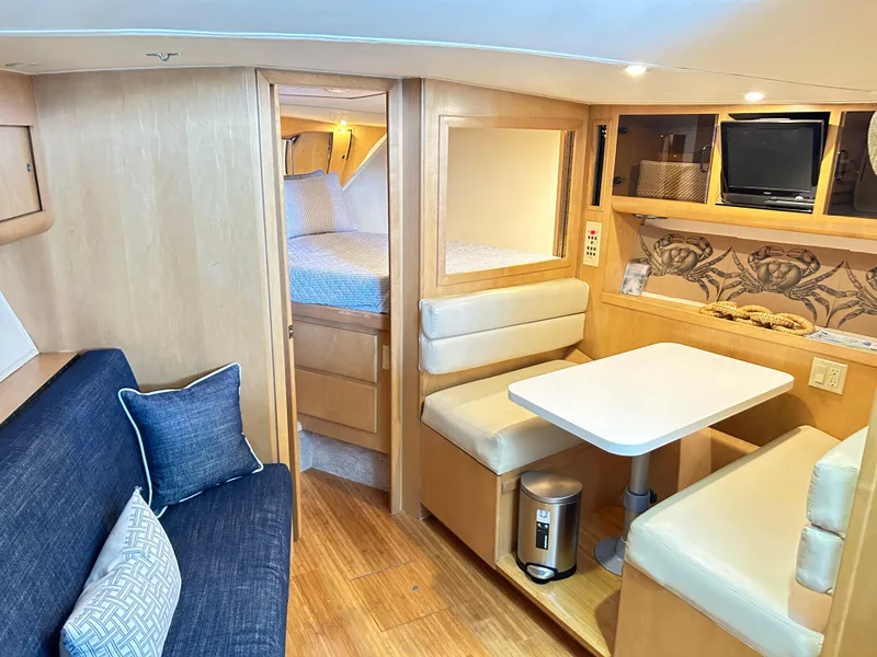 Slide: The Image of Interior of 1996 Hatteras 39 Sport Express yacht with cozy seating and dining area. - 49