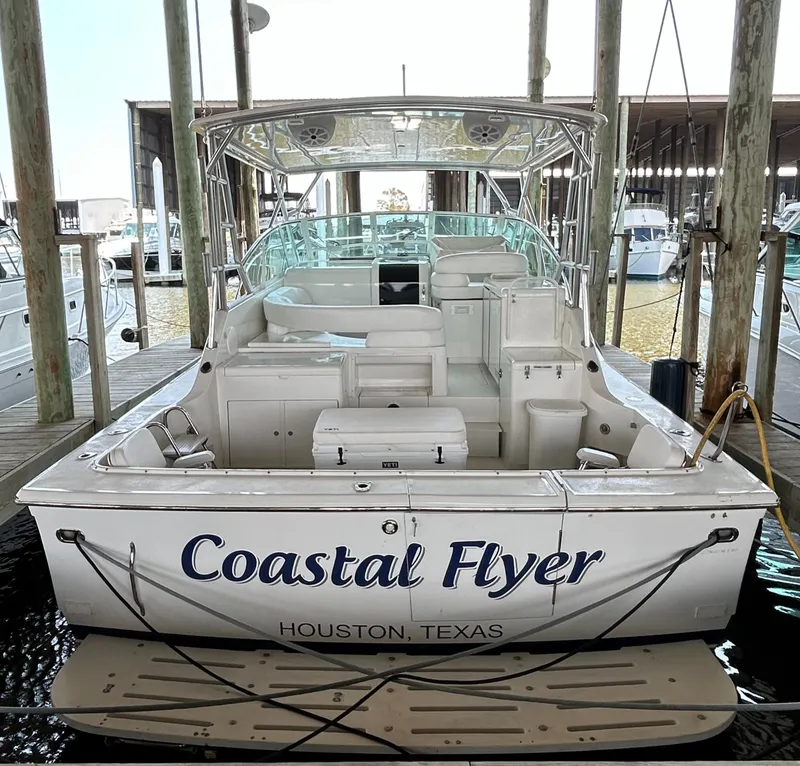 Slide: The Image of 1996 Hatteras 39 Sport Express boat named "Coastal Flyer" docked in Houston, Texas. - 5