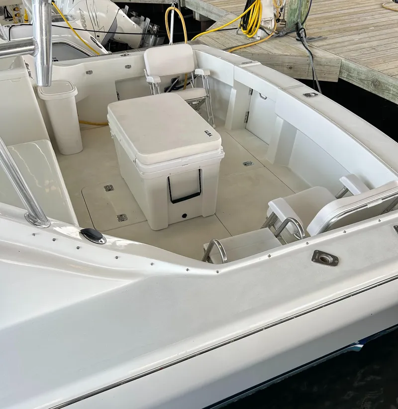 Slide: The Image of 1996 Hatteras 39 Sport Express boat interior with seating and cooler on deck. - 9