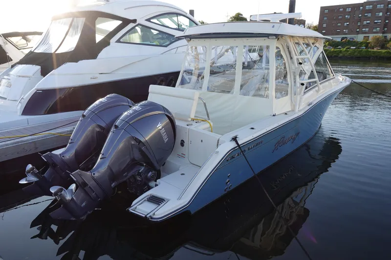 Slide: The Image of 2021 Grady-White Freedom 325 boat docked with twin outboard engines. - 1