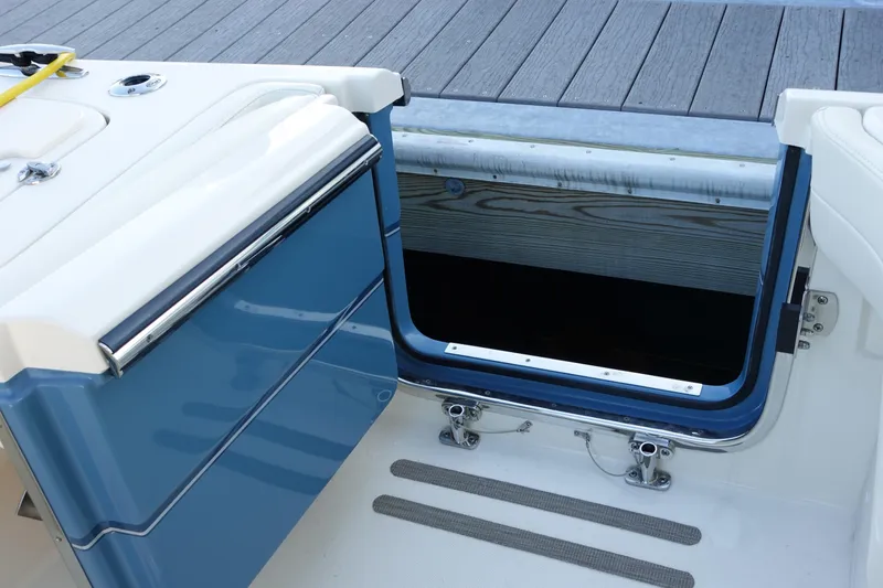 Slide: The Image of 2021 Grady-White Freedom 325 boat with open storage compartment and deck view. - 12