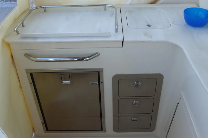 Slide: The Image of 2021 Grady-White Freedom 325 boat interior with storage and sink area. - 13