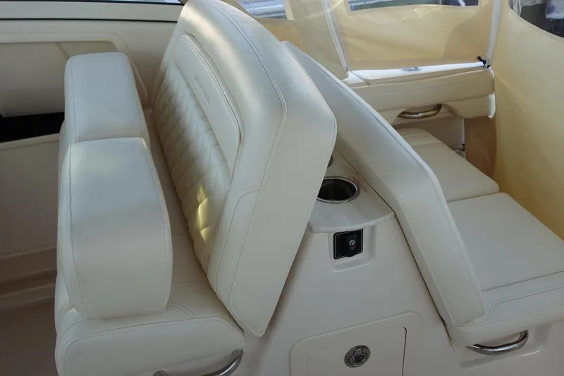 Slide: The Image of 2021 Grady-White Freedom 325 boat interior with beige seating and cup holder. - 15