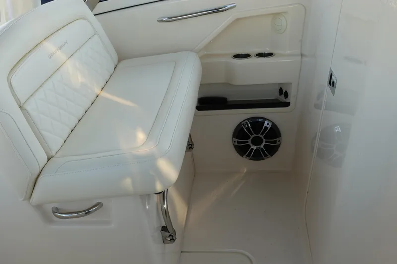 Slide: The Image of 2021 Grady-White Freedom 325 interior seating with speaker and cup holders. - 16