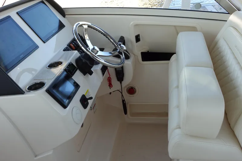 Slide: The Image of 2021 Grady-White Freedom 325 helm with modern controls and plush seating. - 17