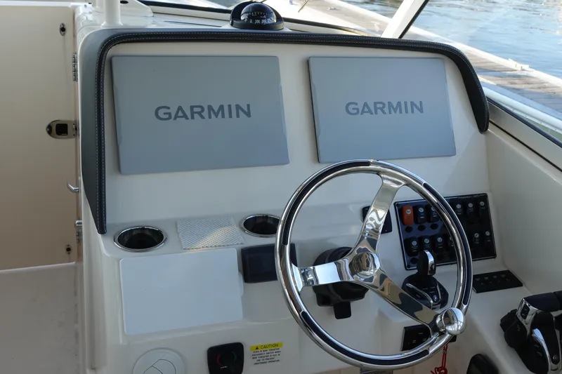 Slide: The Image of 2021 Grady-White Freedom 325 helm with dual Garmin displays and steering wheel. - 18