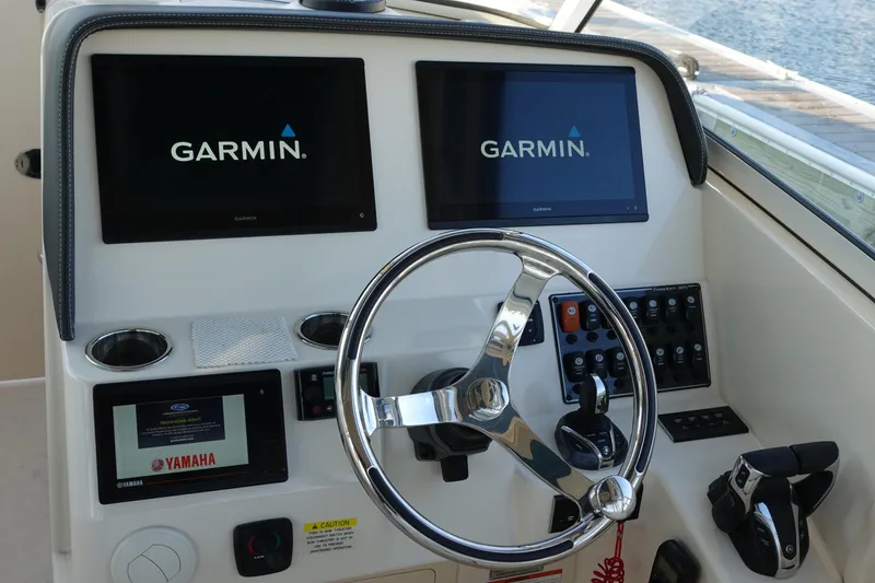 Slide: The Image of 2021 Grady-White Freedom 325 helm with Garmin displays and Yamaha controls. - 19