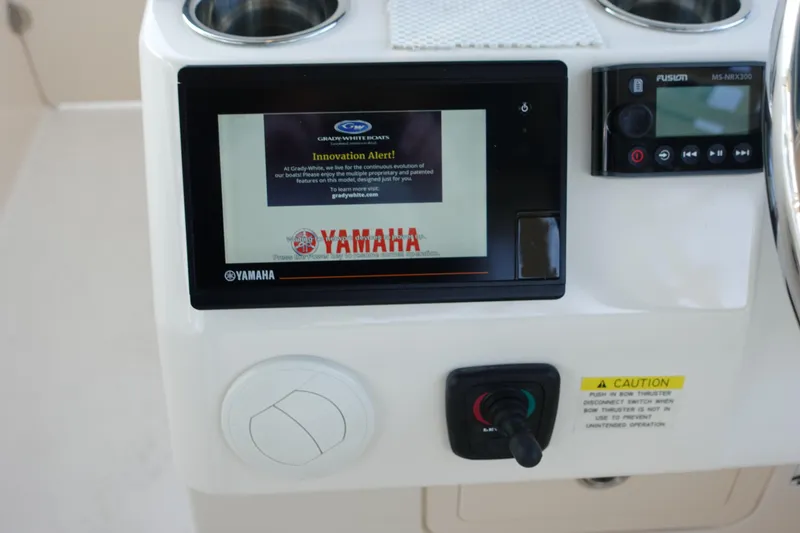 Slide: The Image of Control panel of 2021 Grady-White Freedom 325 boat with Yamaha display and Fusion audio system. - 22