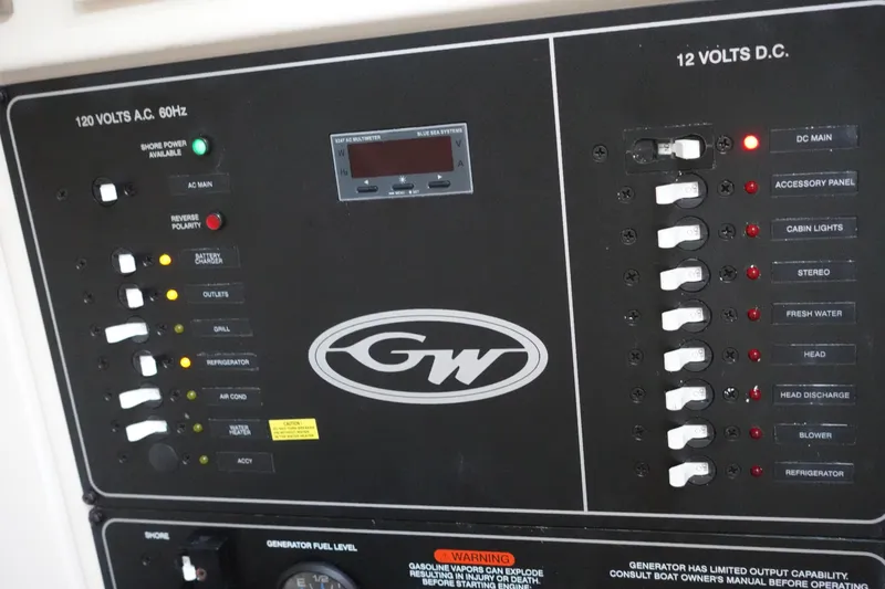 Slide: The Image of Control panel of a 2021 Grady-White Freedom 325 boat, featuring various switches and indicators. - 25